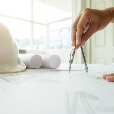 hands-engineer-working-blueprint-construction-concept-engineering-tools-vintage-tone-retro-filter-effect-soft-focus-selective-focus-scaled.jpg